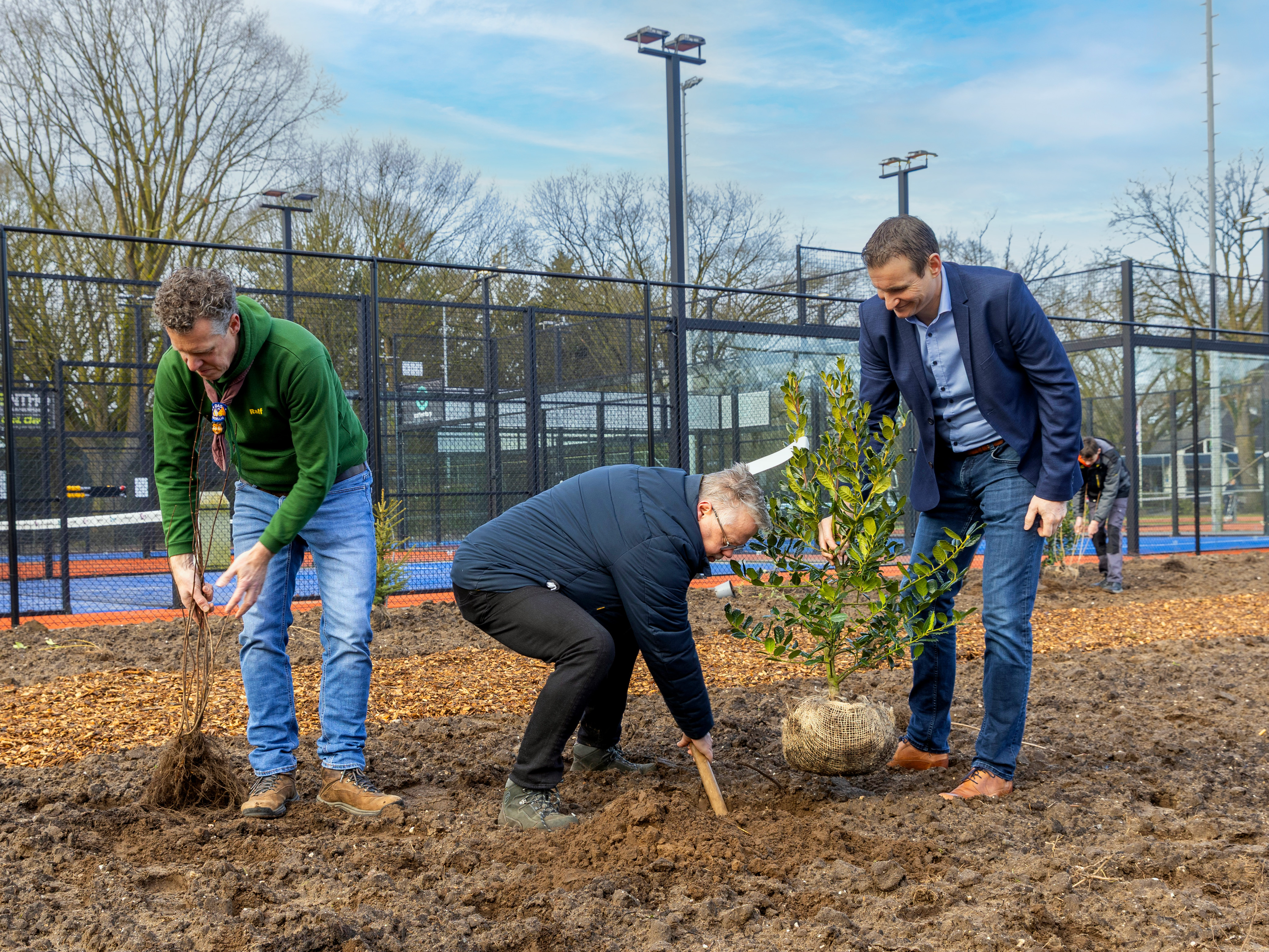 v.l.n.r. Ralf Donkers (scouting Uotha), wethouder Van Den Broek (Sport) en Bart  Kremers (LTC Uden) helpen bij de aanplant van het nieuwe groen op het perceel aan de Boekelsedijk  in Uden